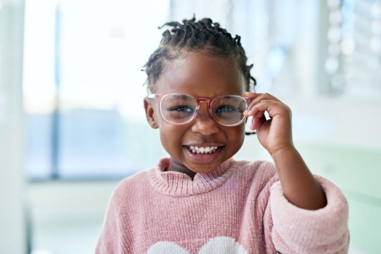 little girl wearing glassess and smiling